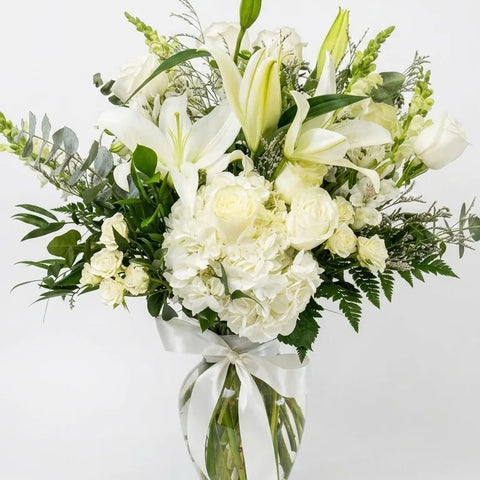 White Lily Tribute Arrangement, hand-arranged by Florent Floral for same-day sympathy flower delivery in Newmarket Ontario