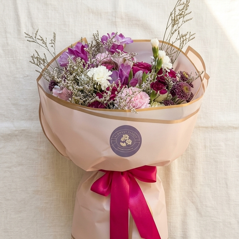 Wrapped bouquet with orchids and roses for Mother's Day delivery in Newmarket Ontario