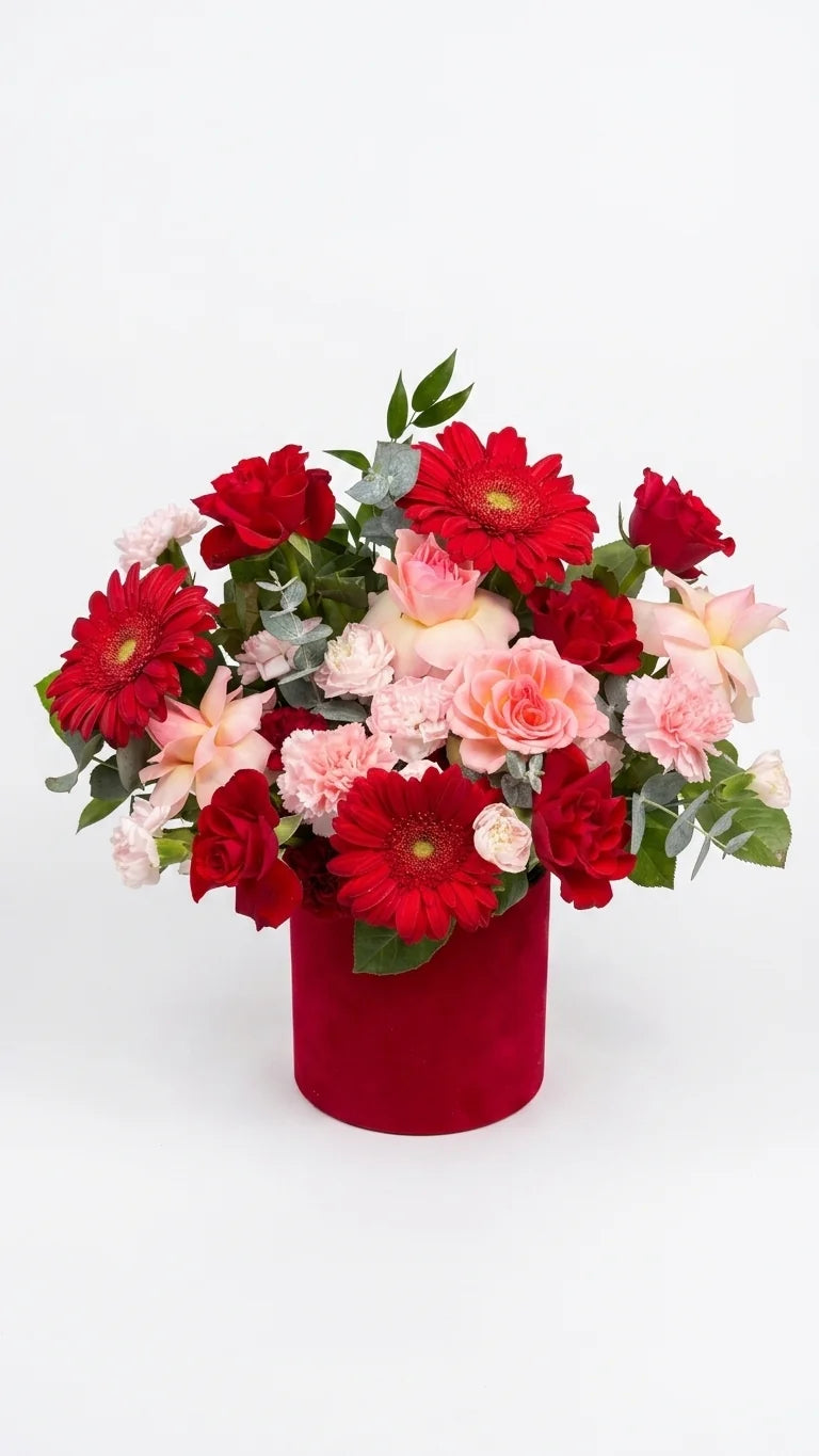 Red gerbera daisies and pink spray roses in a deep red velvet round hat box — Red Velvet Romance Box by Florent Floral Newmarket