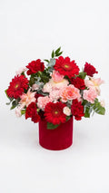 Red gerbera daisies and pink spray roses in a deep red velvet round hat box — Red Velvet Romance Box by Florent Floral Newmarket