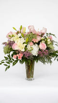 Blush garden-style vase arrangement with roses, lilies, hydrangea and seasonal greenery